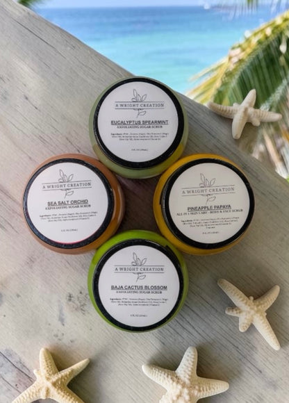 Five small containers of 'A Weight Creation' on a wooden surface with starfish and a beach background.