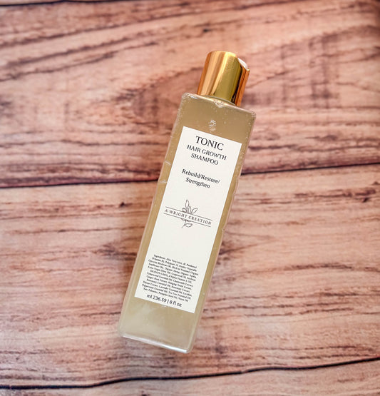 A Wright Creation Tonic Hair Growth Shampoo in eco-friendly packaging with a gold cap, formulated with aloe vera and natural oils to rebuild, restore, and strengthen hair, ideal for sensitive scalps, dry hair, and overall hair health.